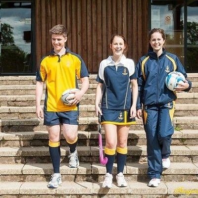 Students in school sports uniforms and house kits