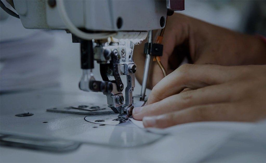 Uniform manufacturing at the Sungrace factory in Jalandhar — stitching line in action
